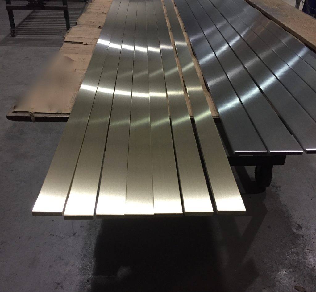 Polished stainless flat bars staged in the shop
