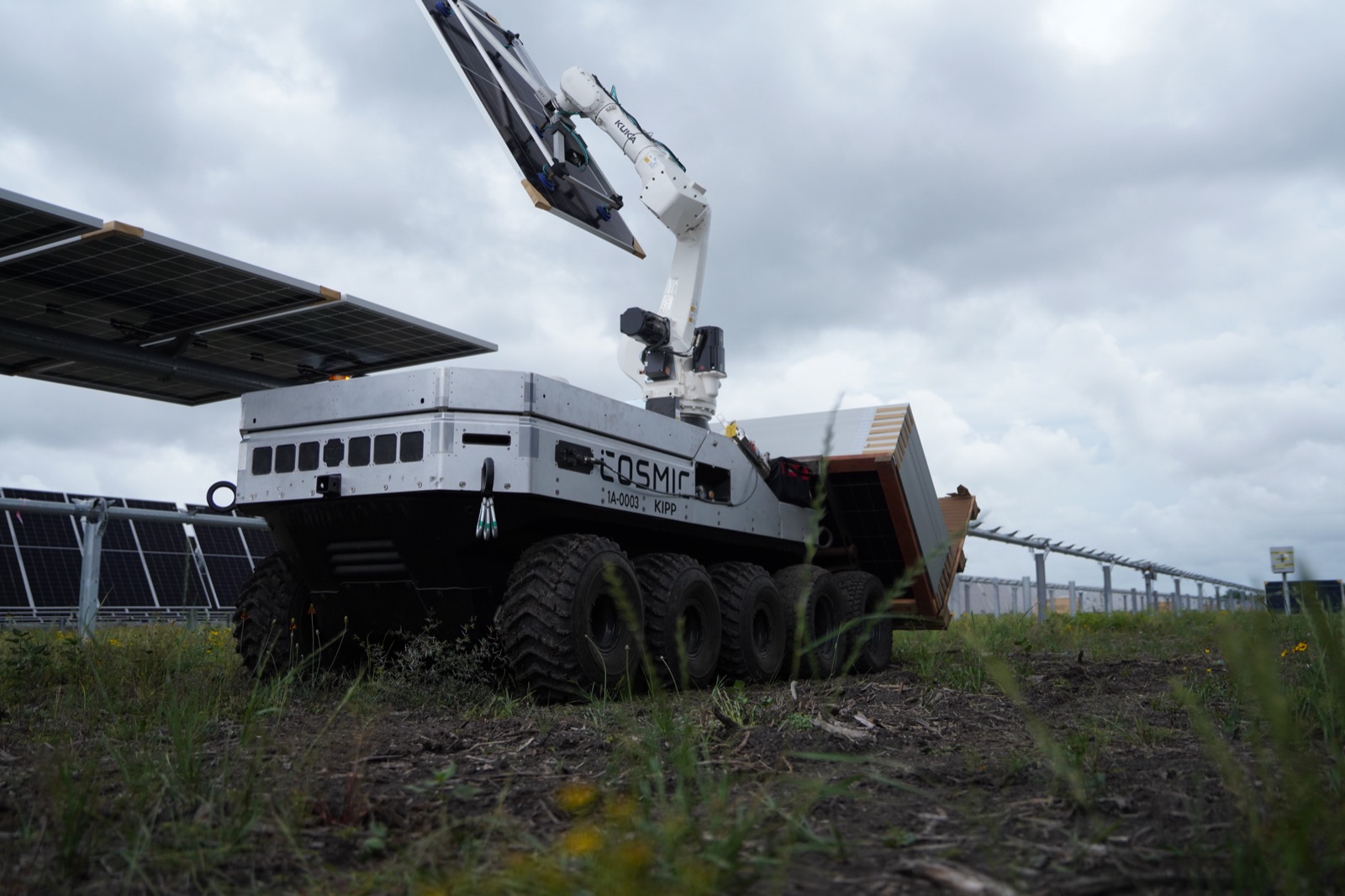 Cosmic-1 lifting a solar module while building a terrestrial solar farm.