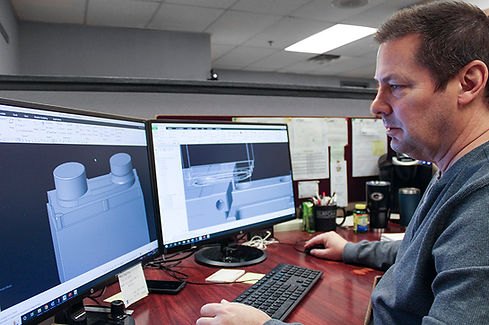 Capabilities page image showing plastic injection mold CNC programming.