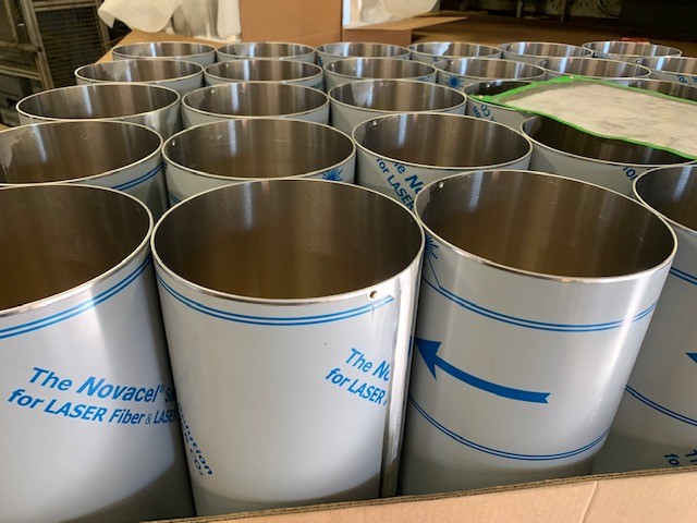 Laser-cut rolled and welded cylinders produced through the CNC roll forming service.