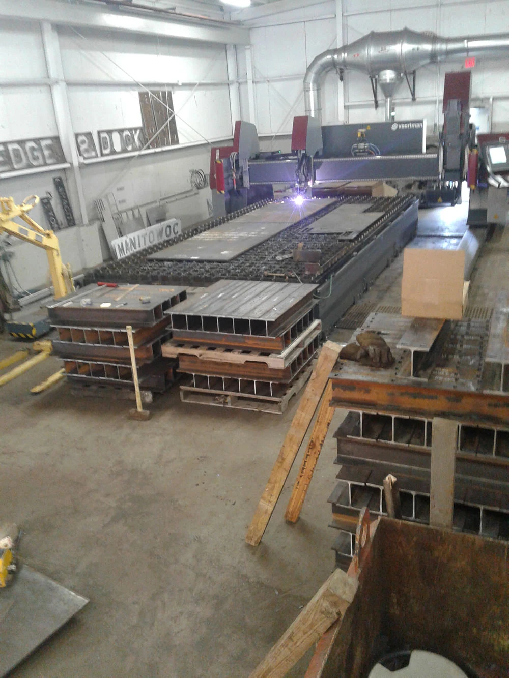 Computer-operated cutting table processing steel plate for large structural components at Mohawk Northeast.