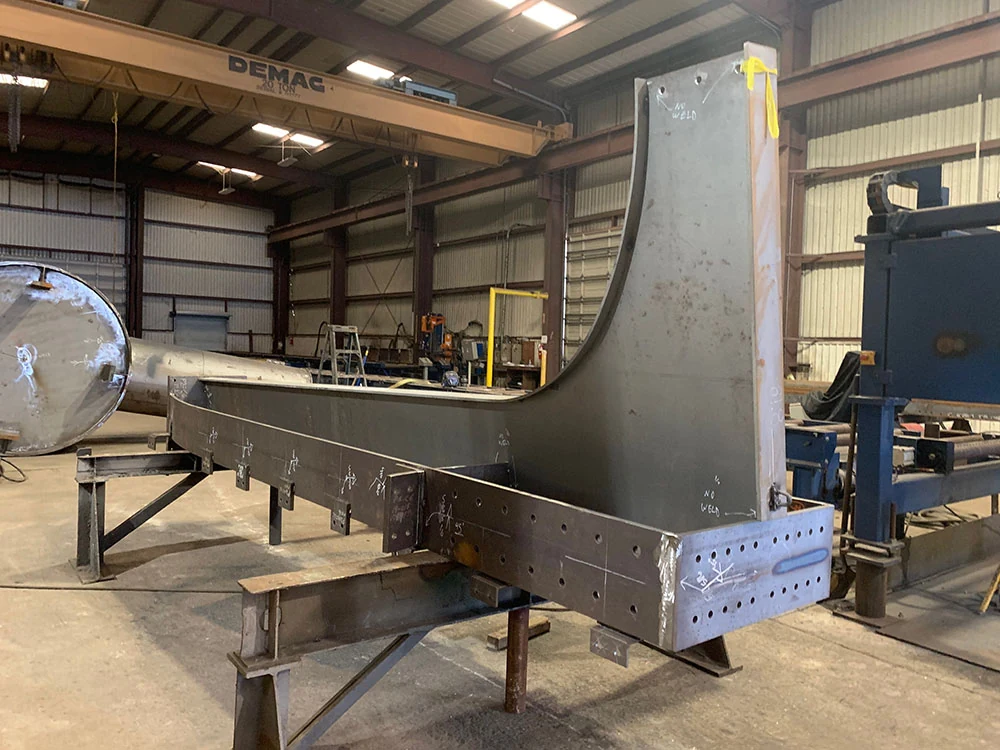 Large structural steel weldment in fit-up inside Mohawk Northeast's fabrication facility.