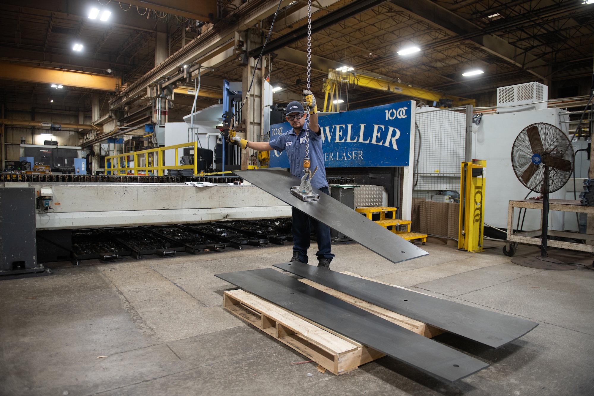 Vacuum lift handling large steel sheet prior to laser cutting.
