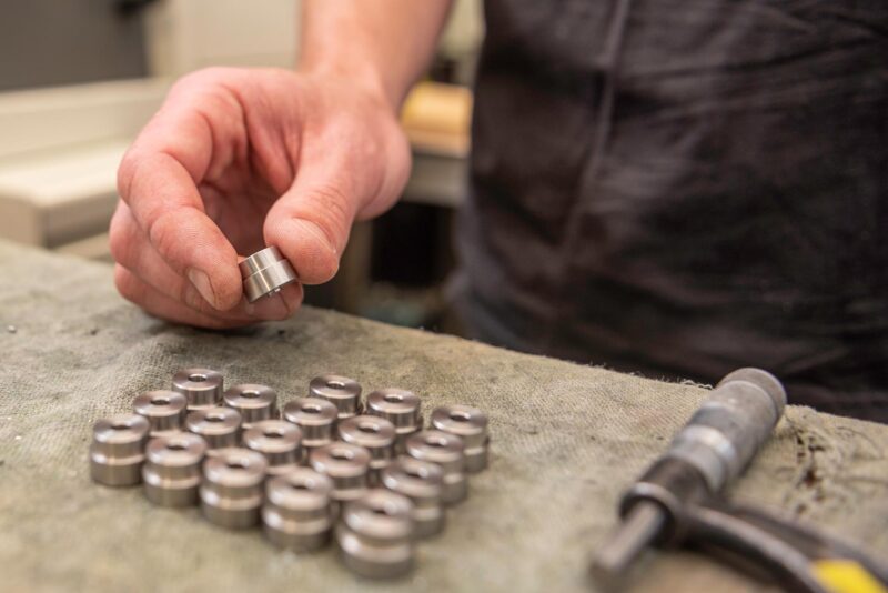 Precision CNC machined bushings with tight tolerance finishing, inspected for dimensional accuracy.