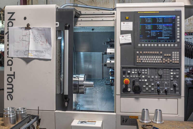 Nakamura-Tome CNC turning center with multi-axis control for precision machining of cylindrical components.