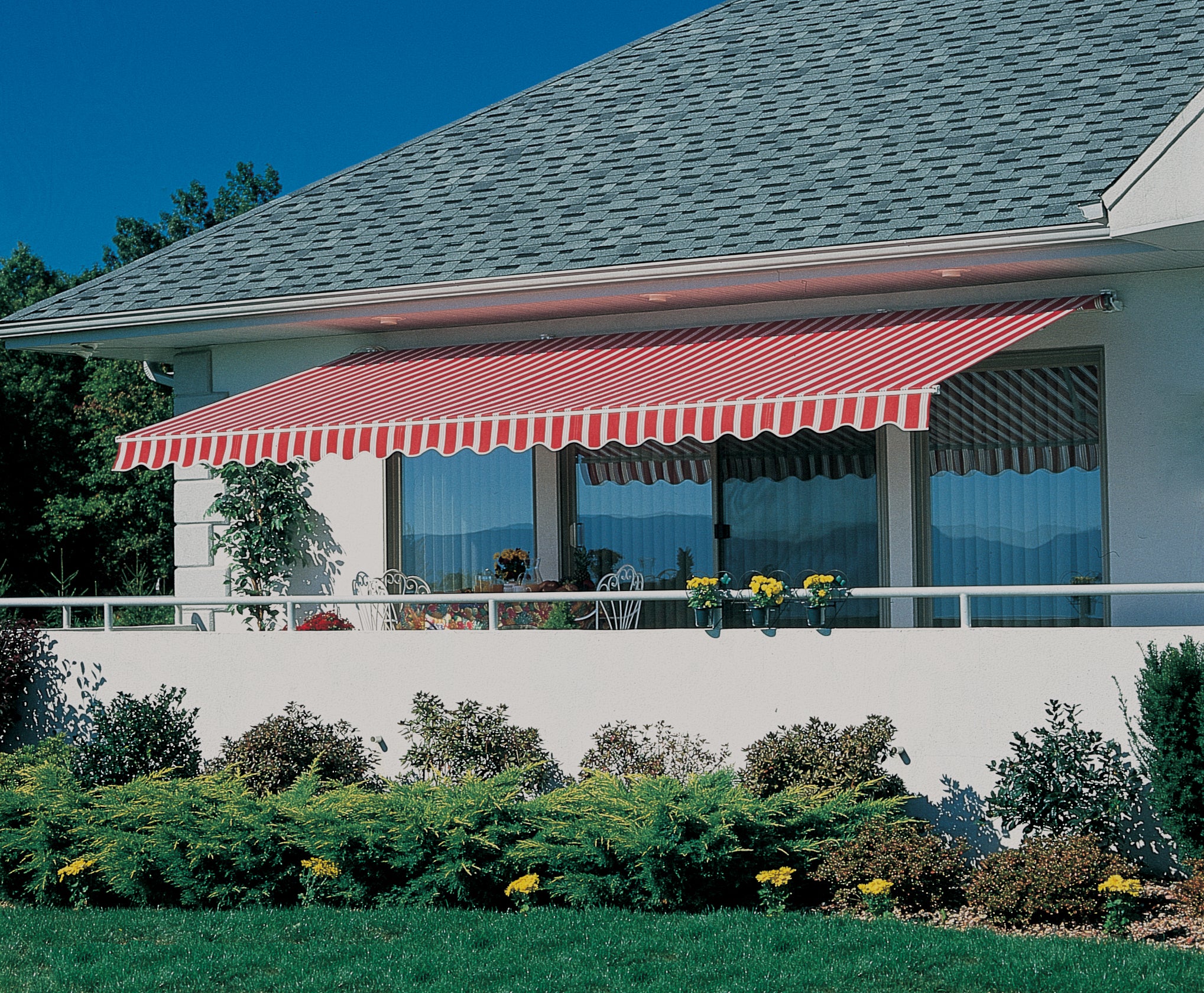 Striped retractable awning shading a residential patio.