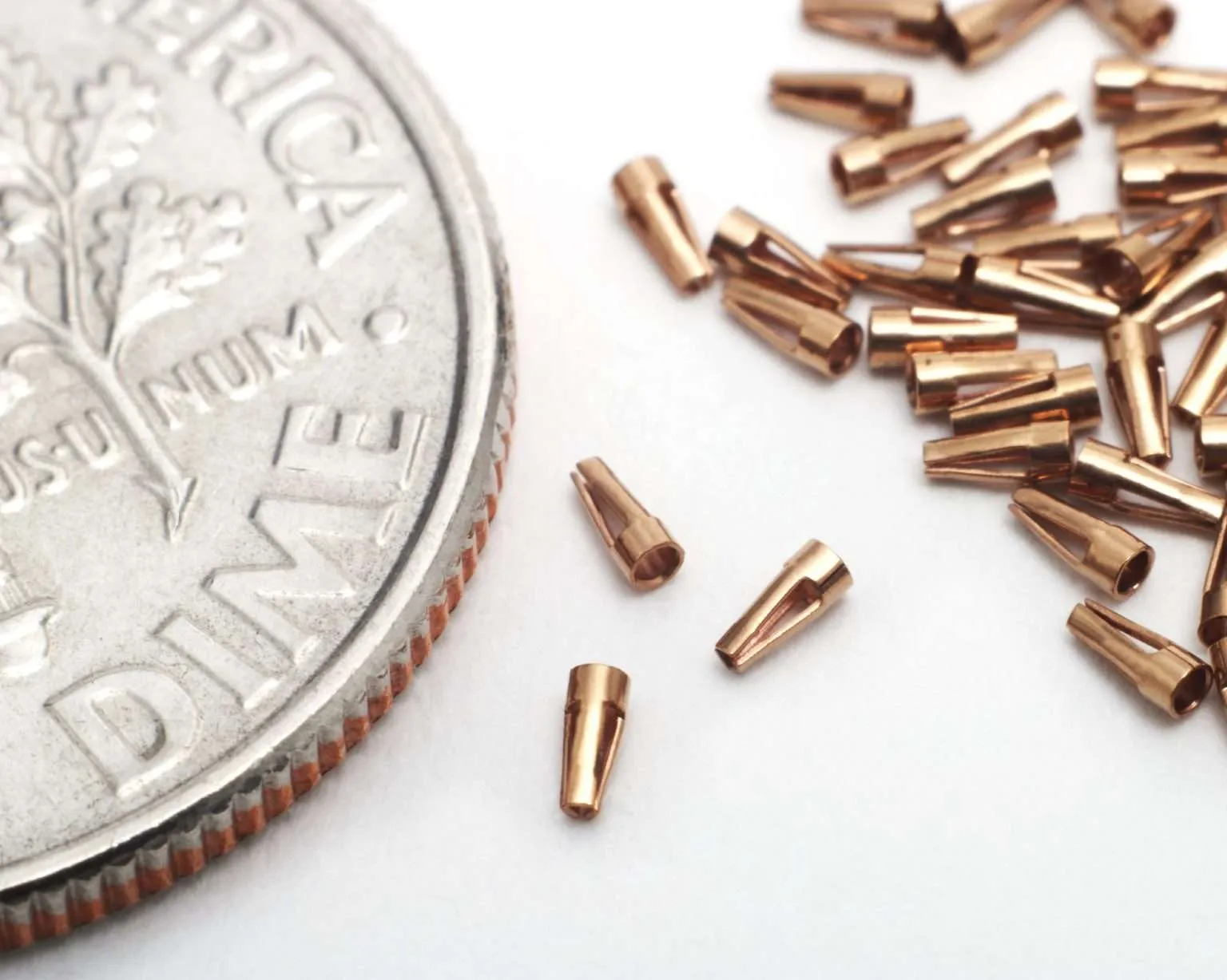 Micro-stamped copper contact terminals shown at dime scale.