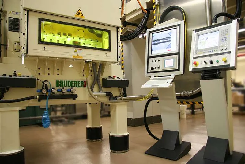 High-speed Bruderer precision metal stamping press with CNC controls.